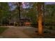 Long driveway leading to a stately brick home, nestled among mature trees and professional landscaping at 10805 The Olde Pl, Raleigh, NC 27614
