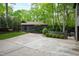 Concrete driveway and lush lawn leading up to an additional home structure surrounded by nature at 10805 The Olde Pl, Raleigh, NC 27614