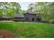 Beautiful home with well manicured lawn and a quaint side building providing extra storage or living space at 10805 The Olde Pl, Raleigh, NC 27614