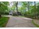 Exterior view showcasing a driveway leading to a well-maintained house surrounded by lush greenery at 10805 The Olde Pl, Raleigh, NC 27614
