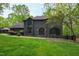 Charming two-story home with a modern brick exterior, large windows, and well-manicured lawn at 10805 The Olde Pl, Raleigh, NC 27614