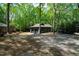Two car garage surrounded by mature trees and a leafy landscape at 10805 The Olde Pl, Raleigh, NC 27614