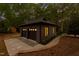 Night view of a two-car garage featuring warm interior lighting and a well-manicured exterior at 10805 The Olde Pl, Raleigh, NC 27614