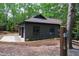 Garage exterior showing gray brick, black trim and a mulched landscape at 10805 The Olde Pl, Raleigh, NC 27614