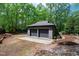 Two car garage surrounded by a leafy landscape at 10805 The Olde Pl, Raleigh, NC 27614