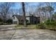 Garage and additional building on property with lush landscaping and mature trees at 10805 The Olde Pl, Raleigh, NC 27614