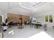 Expansive garage featuring a workstation, storage, art space, and natural light from the windows at 10805 The Olde Pl, Raleigh, NC 27614
