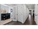 Hallway with a laundry area featuring modern black appliances and a large window at 10805 The Olde Pl, Raleigh, NC 27614