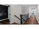 Hallway with dark hardwood floors, neutral walls, and black trim, showcasing elegant architectural details at 10805 The Olde Pl, Raleigh, NC 27614