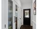 Hallway with pantry doors, closet doors and front door at 10805 The Olde Pl, Raleigh, NC 27614