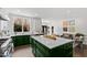 Spacious kitchen with green lower cabinets, white upper cabinets, large island, and backyard views at 10805 The Olde Pl, Raleigh, NC 27614