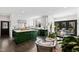 Open-concept kitchen flows into a cozy seating area with large windows and natural light at 10805 The Olde Pl, Raleigh, NC 27614