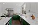 Bright kitchen features green and white cabinets, stainless steel appliances, and marble countertops at 10805 The Olde Pl, Raleigh, NC 27614