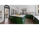 Modern kitchen with green cabinets, stainless steel appliances, a large island, and an open doorway at 10805 The Olde Pl, Raleigh, NC 27614