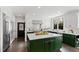 Well-lit kitchen features a large island with marble countertops and modern stainless steel appliances at 10805 The Olde Pl, Raleigh, NC 27614