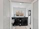 Well-lit laundry room featuring modern black appliances and a convenient folding area at 10805 The Olde Pl, Raleigh, NC 27614