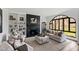 Inviting living room boasting a fireplace with built-in shelving and a large arched window offering natural light at 10805 The Olde Pl, Raleigh, NC 27614
