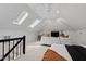 View of the open-concept living room, which includes carpeted floors, skylights, and a sofa at 10805 The Olde Pl, Raleigh, NC 27614