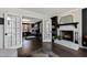 Open living room with fireplace and french doors leading into primary bedroom at 10805 The Olde Pl, Raleigh, NC 27614