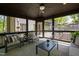 Relaxing screened-in porch with neutral furniture and view of surrounding landscape at 10805 The Olde Pl, Raleigh, NC 27614