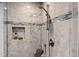 Beautiful, tiled shower stall with a built in shelf and modern shower head at 10805 The Olde Pl, Raleigh, NC 27614