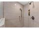 Elegant shower with neutral tile, handheld sprayer, and built-in soap and shampoo dispensers at 10805 The Olde Pl, Raleigh, NC 27614