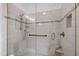 Modern shower with tiled walls, a glass door, and built-in shelving for toiletries, offering a spa-like experience at 10805 The Olde Pl, Raleigh, NC 27614