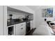 Convenient wet bar area with wine fridge, countertop, storage cabinets, and modern fixtures at 10805 The Olde Pl, Raleigh, NC 27614