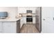 Modern kitchen with stainless steel appliances, white cabinets, and granite counters at 110 Red Maple St, Sanford, NC 27332