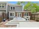 Inviting back deck with gray siding and brick accents, complete with a cozy seating area at 120 Barbary Ct, Cary, NC 27511