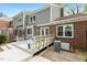 Spacious back deck with gray siding and brick, complete with outdoor seating and greenery at 120 Barbary Ct, Cary, NC 27511