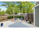 Backyard patio offers a serene spot for outdoor relaxation, complemented by lush landscaping and privacy fencing at 120 Barbary Ct, Cary, NC 27511