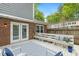 The backyard patio offers a pleasant area to sit with seating, complemented by a fenced-in yard and trees at 120 Barbary Ct, Cary, NC 27511