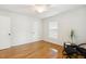 Bright bedroom with hardwood floors, a ceiling fan, and a sun-filled window at 120 Barbary Ct, Cary, NC 27511