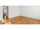 Bedroom with hardwood floors, neutral paint, and a view into another room at 120 Barbary Ct, Cary, NC 27511