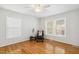 Bright bedroom features hardwood floors and plenty of natural light with a relaxing armchair at 120 Barbary Ct, Cary, NC 27511