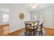 Dining area with hardwood floors, a modern ceiling fan and doors to outside at 120 Barbary Ct, Cary, NC 27511