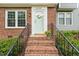 Inviting front entrance with brick steps, black railing, and a white front door with decorative wreath at 120 Barbary Ct, Cary, NC 27511