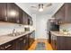 Galley kitchen with stainless steel appliances, dark cabinets, light countertops, and hardwood floors at 120 Barbary Ct, Cary, NC 27511