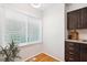 Bright kitchen nook with a plant near the window and dark cabinets for storage at 120 Barbary Ct, Cary, NC 27511