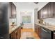 Kitchen with stainless steel appliances, dark cabinets and light countertops plus large window at 120 Barbary Ct, Cary, NC 27511