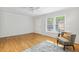 Bright living room featuring hardwood floors, a large window, and neutral paint at 120 Barbary Ct, Cary, NC 27511