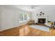 Inviting living room features hardwood floors, fireplace, neutral paint and plenty of natural light at 120 Barbary Ct, Cary, NC 27511
