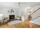 Cozy living room featuring hardwood floors, fireplace, and staircase at 120 Barbary Ct, Cary, NC 27511