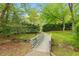 Scenic park bridge surrounded by lush greenery, creating a tranquil and inviting outdoor space at 120 Barbary Ct, Cary, NC 27511