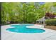 Large community pool surrounded by lush greenery, offering a relaxing and private oasis at 120 Barbary Ct, Cary, NC 27511