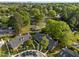 An aerial view showcases a community, with mature trees and residential homes in a lush landscape at 1234 Shadowbark Ct, Raleigh, NC 27603