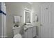 Cozy bathroom featuring a white vanity, lighted mirror, and classic fixtures at 1234 Shadowbark Ct, Raleigh, NC 27603