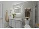 A bathroom that has a lit mirror, granite counters, and towel racks on the walls at 1234 Shadowbark Ct, Raleigh, NC 27603