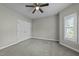 Bedroom with window and fan features a neutral color scheme and double door closet at 1234 Shadowbark Ct, Raleigh, NC 27603
